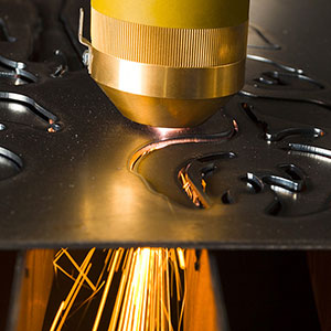 Laser machine cutting a sheet of metal